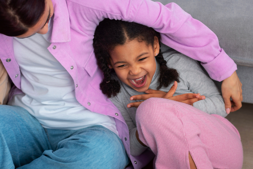 High angle mother tickling girl