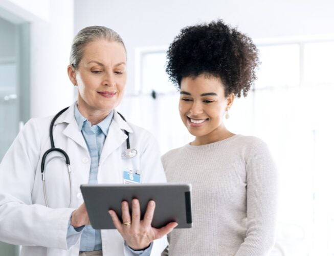 A young woman talks to her doctor about Colorado Springs mental health treatment.