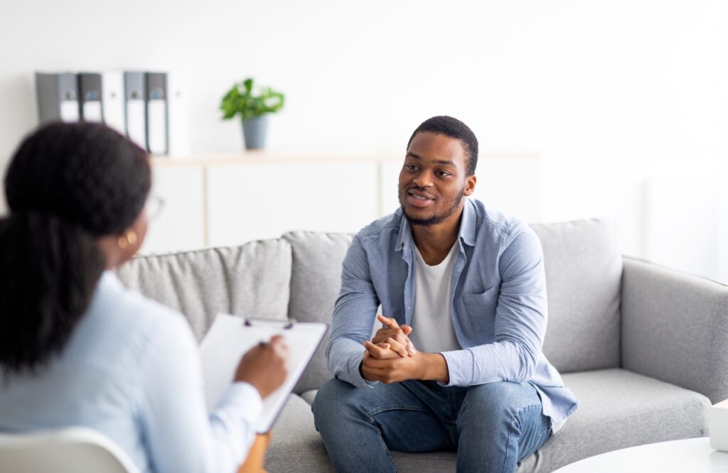 A man talks to his primary therapist during addiction treatment programs in Colorado Springs.