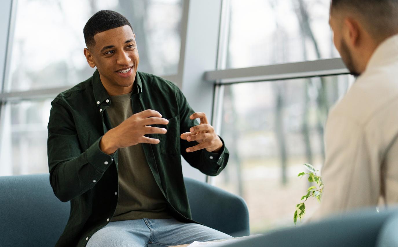 Man engaged in an open and supportive discussion during therapy.