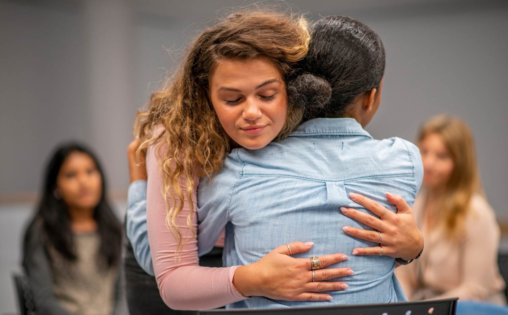 Woman comforting a friend during heroin addiction treatment in Colorado Springs.