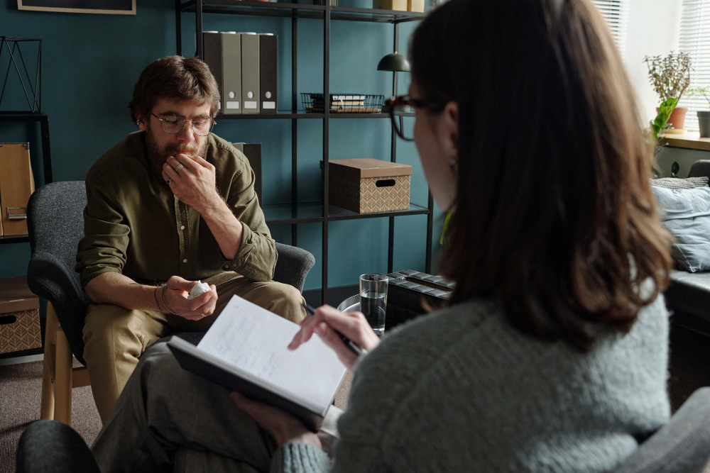 Man speaking with therapist during hydrocodone addiction treatment in Colorado Springs counseling session