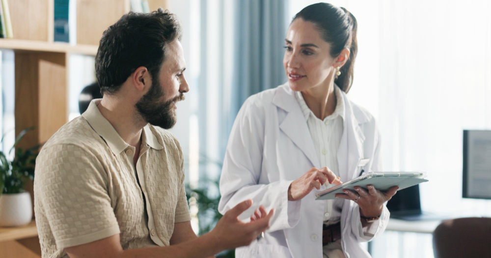 Doctor and patient reviewing health information on a tablet during oxycodone rehab in Colorado Springs at Drift Behavioral Health.