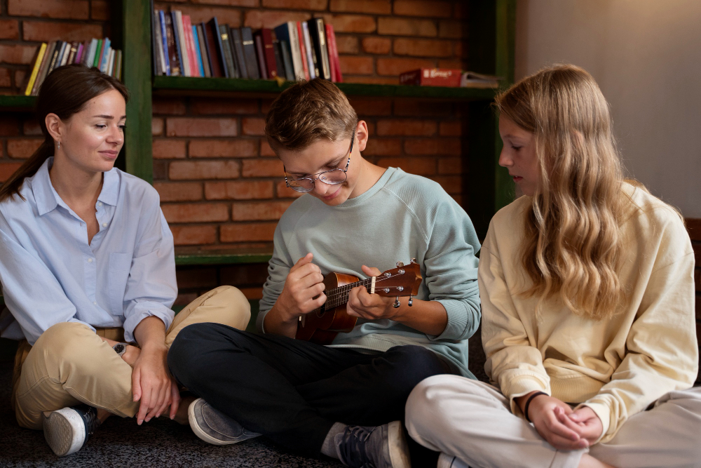 Teen playing ukulele while talking with a therapist about teen anxiety warning signs at Drift Behavioral Health.