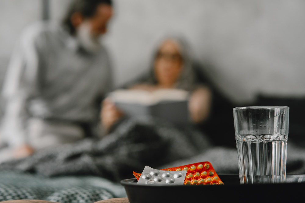 Older adults taking medication with water while learning about benzodiazepine withdrawal symptoms at Drift Behavioral Health.
